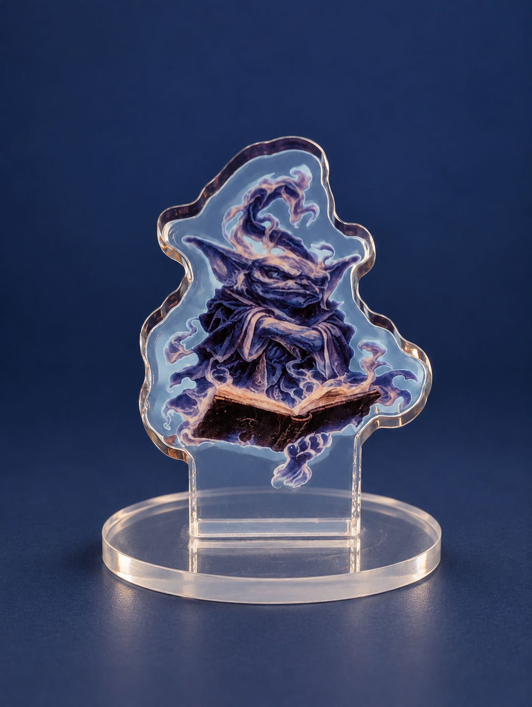 Close-up of a purple magical character acrylic standee with an open book, a clear cut edge and round base.