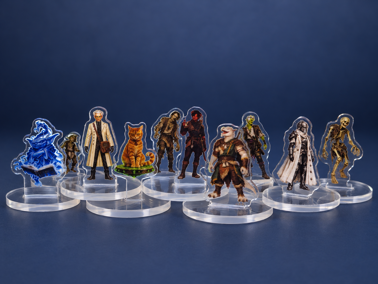 A group of colourful test acrylic standees, including fantasy adventurers, a cat, and a skeleton, standing on clear round bases in front of a waterfall backdrop.